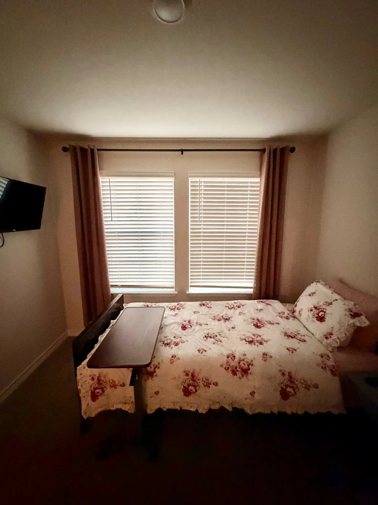 Comfortable resident bedroom with TV and natural light at Comfort Care Home